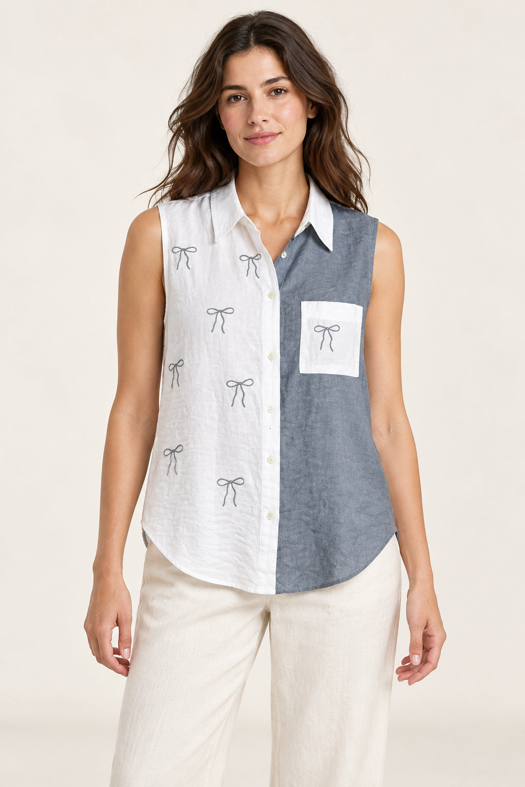 Grey and white sleeveless bow shirt on a model, front view