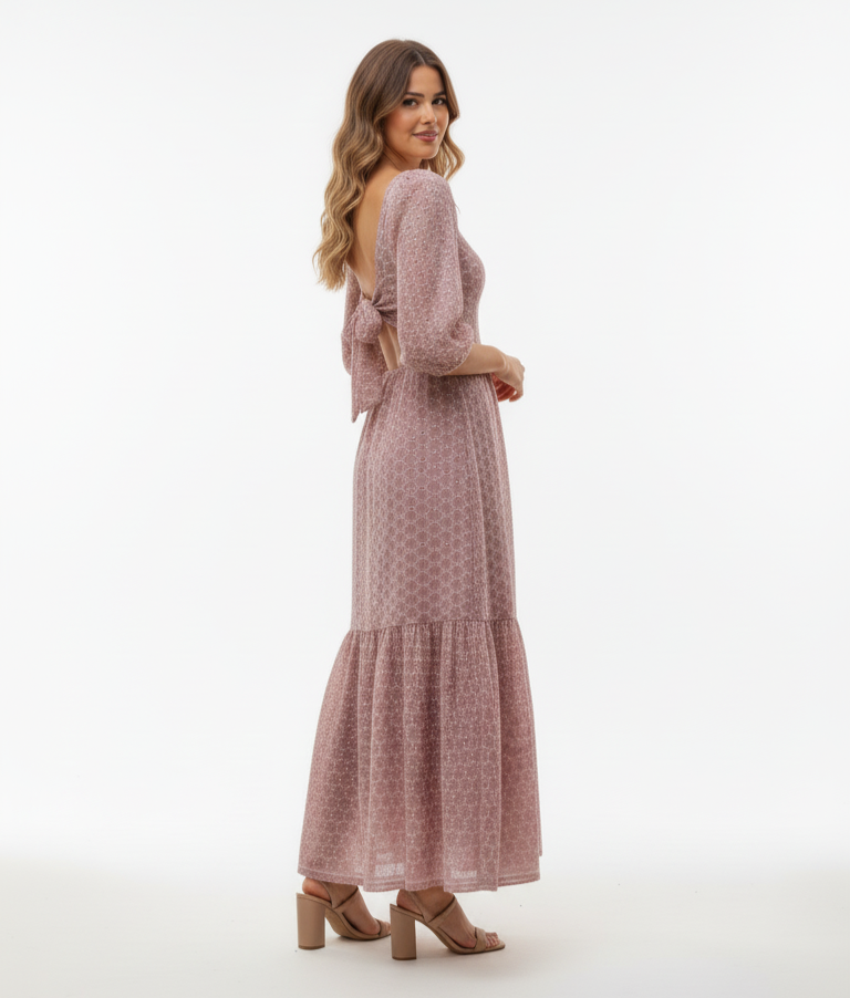Woman wearing a pink dress with a white background