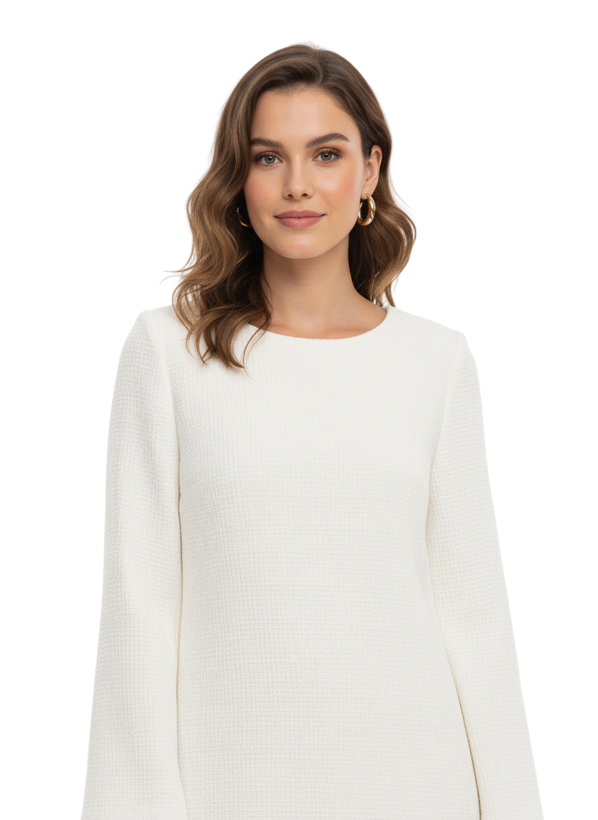 Woman wearing a white dress against a plain background
