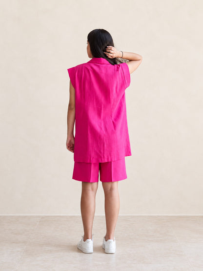 Fuchsia sleeveless vest and matching shorts set on a model, back view