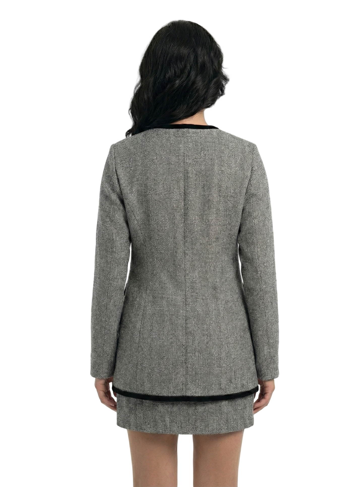 Person wearing a gray blazer and skirt set on a white background