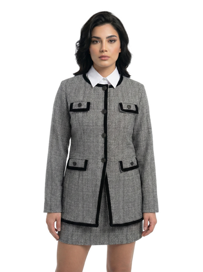 Woman wearing a gray coat with black accents on a white background