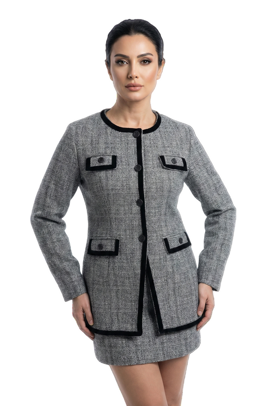 Woman wearing a gray checkered dress with black accents on a white background