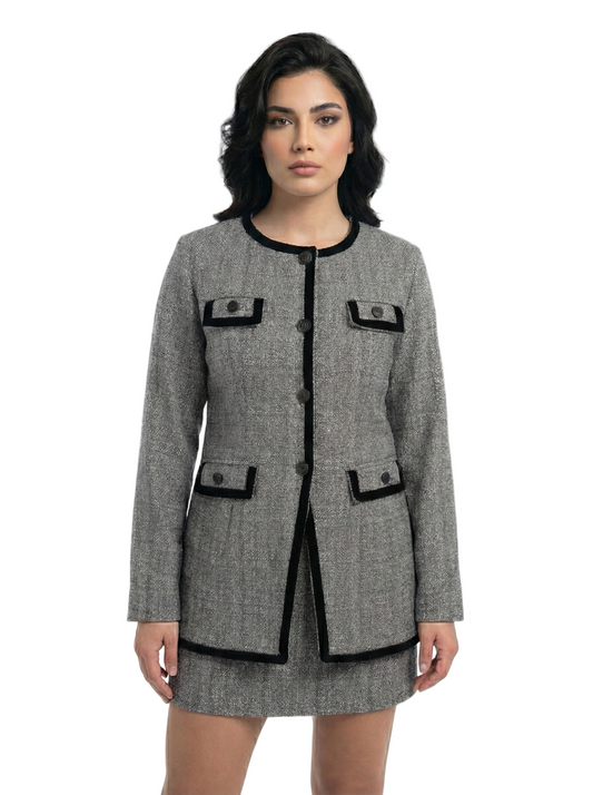 Woman wearing a gray coat with black accents on a white background