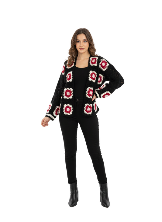 Woman wearing a black cardigan with red and white pattern on a white background